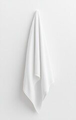 White towel hanging on a white wall.