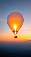 Fototapeta premium A vibrant hot air balloon floats gracefully against a stunning sunset sky, illuminating the scene with warm hues.