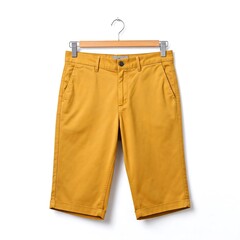 Yellow capri pants hanging on white background