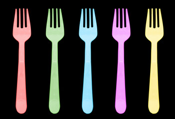 Multi color plastic fork isolated on black background. Disposable tableware set isolated