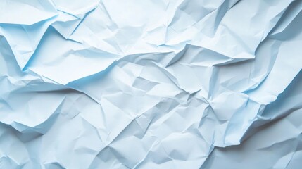 Obraz premium Crumpled light blue paper background with visible folds and texture, adding a rustic and authentic look, on solid white background.