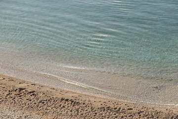  Background of blue sea, white sand and small pebbles. High quality photo
