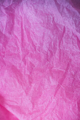 Pink crumpled paper surface background.