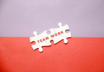 Team or teamwork symbol on yellow background surrounded by puzzle pieces. Business concept.