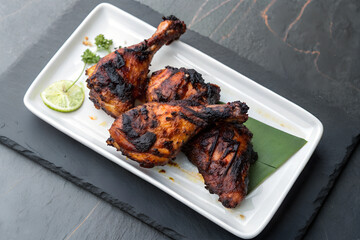 Perfectly Grilled Spicy Chicken on white plate – Indian Tandoori Dish, Top view