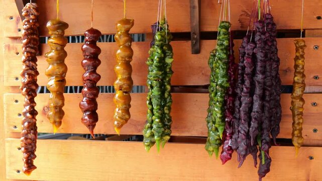Colorful Traditional Georgian Churchkhela Hanging on Wooden Display Background