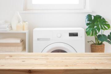 Empty wooden table mockup for design in blurred laundry room