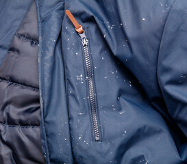 A blue jacket with a zipper pocket