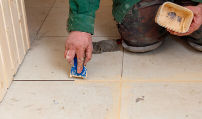 A man is kneeling on the floor