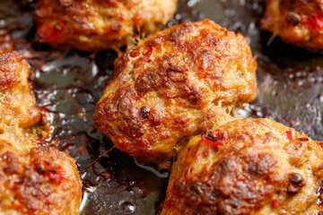 A plate of meatballs with a lot of oil on them