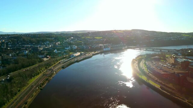 Aerial video of the Derry City in Derry-Londonderry, NI on a sunny day. Showing the River Foyle and the Bogside and Waterside areas of the city. Filmed in 4K at 60fps and in Rec709 color space.