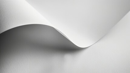 A close-up of smooth, white paper displaying gentle curves and textures.