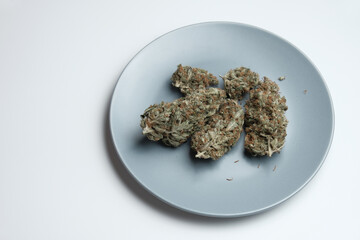 Dried marijuana buds on a plate. Wedding cake strain