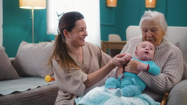 80s grandmother holds a newborn grandson in her lap who talks cutely and feels comfortable. Three-generation family gathering concept at home
