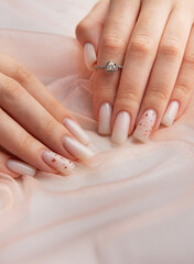Fototapeta premium Female hands with fashionable ombre manicure on pink background
