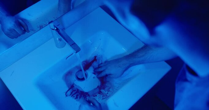 bathroom story: a man cleans the blood from the sink