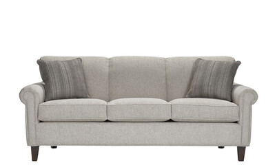 A sofa with pillows in a minimalist design with wooden legs + clipping path. The sofa is isolated on a White background.