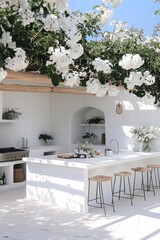 An inviting outdoor kitchen adorned with vibrant flowers and a sleek white design under a bright blue sky.