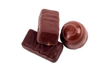 chocolate with filling inside. there are three of them. one candy is round. close-up. there are three of them.