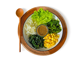 Mix steamed vegetables salad with peanut sauce dressing served in a white plate over wood tray with wooden spoon isolated on white background with clipping path. Top view Flat lay