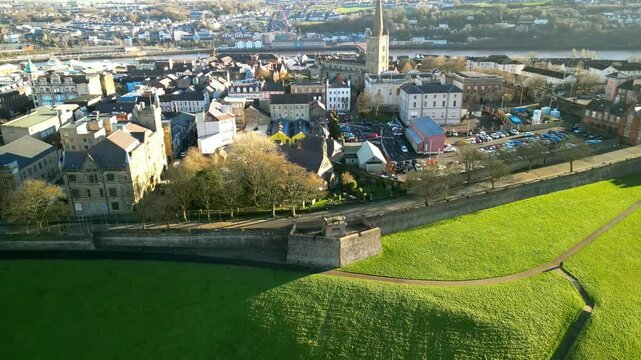 Aerial of The Derry Walls in Derry-Londonderry, Northern Ireland on a bright sunny day. The camera moves right to left, showing Derry City. Filmed in 4K at 30fps with Rec709 color.