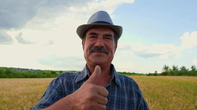 indian american man satisfied farmer looking at camera and showing thumb up