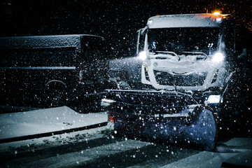 Snow Plow Truck Clearing Snow on a Road in the Middle of the Night During Winter Maintenance...
