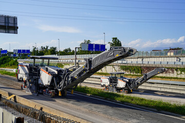 An asphalt milling machine operating on a highway construction site. © Redline Visuals