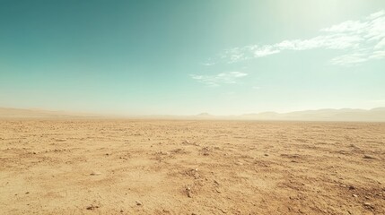 Naklejka premium Vast, arid desert landscape under a clear, bright sky.