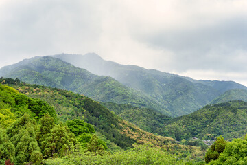 Beautiful scenic natural landscape with the tree covered mountains in Arashiyama district of Kyoto.