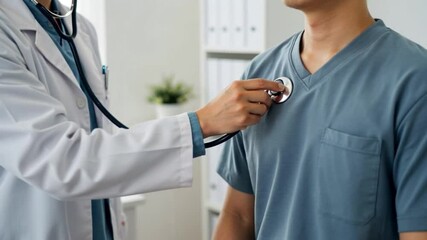 Doctor using stethoscope to examine patient's heart during medical checkup