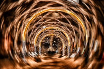 Abstract defocused background forming a funnel of a luminous night street arcade and golden circles