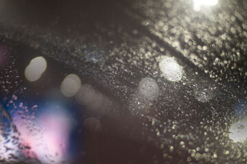Blurred background with raindrops and lights.