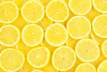 A slices of fresh juicy yellow lemons.  Texture background, pattern.