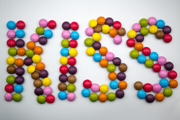 Kiss, word made of colorful candies	
