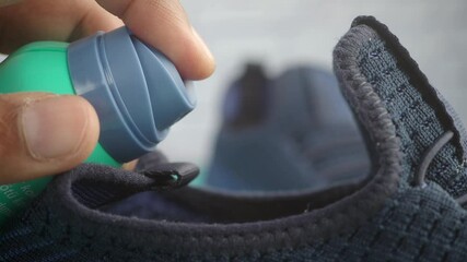Closeup of Spraying shoe freshener