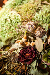 A visually appealing composition of dried flowers, assorted nuts, and natural materials for decoration