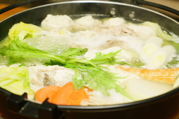 Hot pot with fish meat, vegetables, chicken meatballs and mushrooms as ingredients, a classic Japanese winter dish