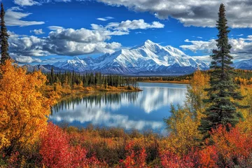 Autumnal Alaskan lake reflecting snow-capped mountains
