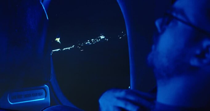 a man in an airplane has fear of flying when the plane takes off