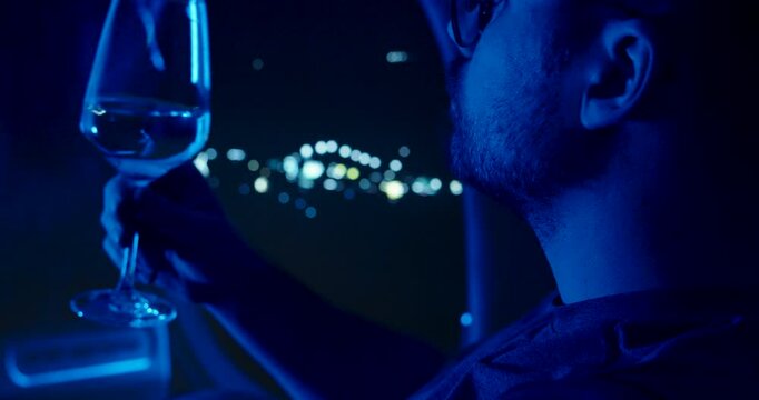 a man sits in an airplane and drinks wine, night flight