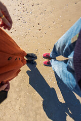 girl and boy holding hands. walk on the beach.