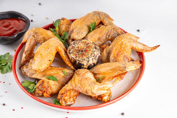 Grilled roasted spicy chicken wings with ketchup