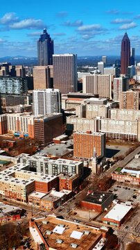 Urban landscape of modern American city downtown. Daytime scenery of Atlanta, Georgia, USA from aerial perspective. Vertical video