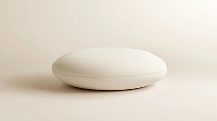 White round cushion, minimalist studio shot, beige background, product display