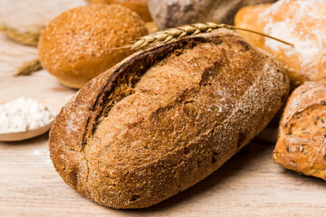 Homemade natural breads. Different kinds of fresh bread as background, perspective view with copy space