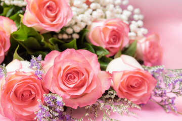 Close up of beautiful pink roses bouquet on pink background
