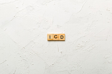 icd word written on wood block. international classification diseases text on table, concept