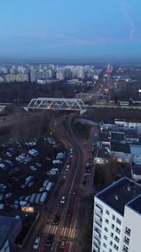 Drone view of Warsaw&rsquo;s urban infrastructure, featuring a busy bridge with dynamic traffic patterns against the backdrop of the city skyline.
