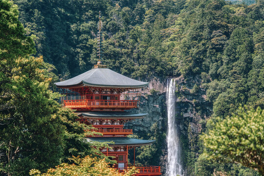 The red three-story pagoda of Seigantoji Buddhist Temple in front of Nachi Falls. Beautiful natural scenery in Nachikatsuura, Japan